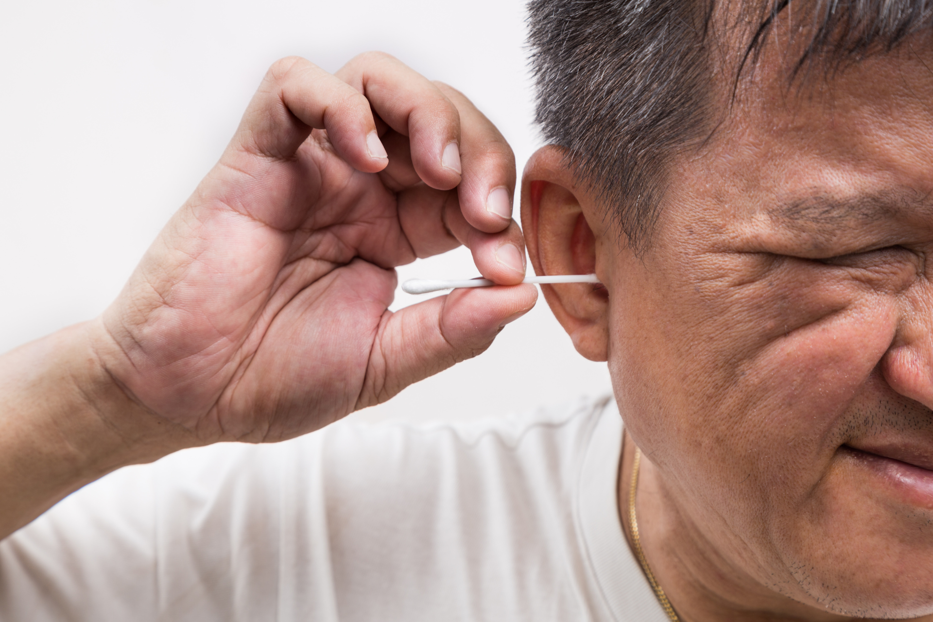 Man putting cotton swab in his ear