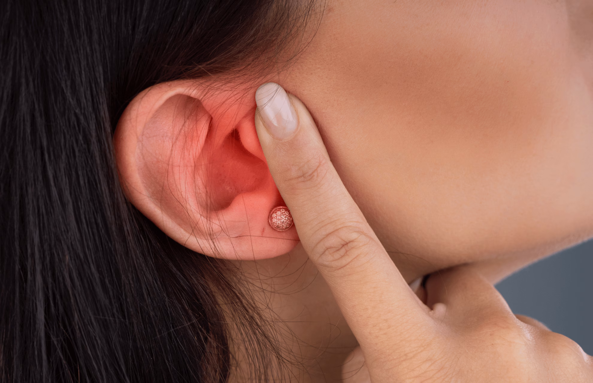 Woman experiencing Otitis Media induced ear pain